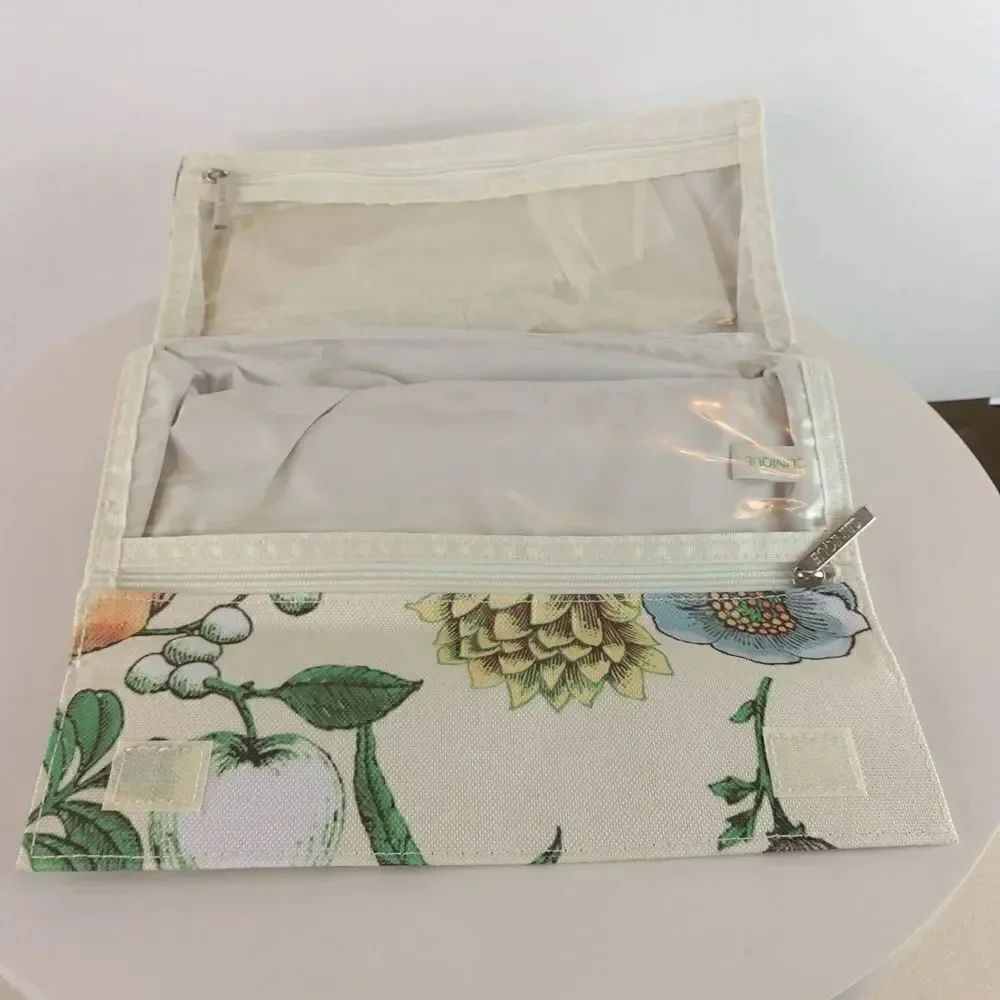 Clinique cream floral print fold over makeup / jewelry bag.